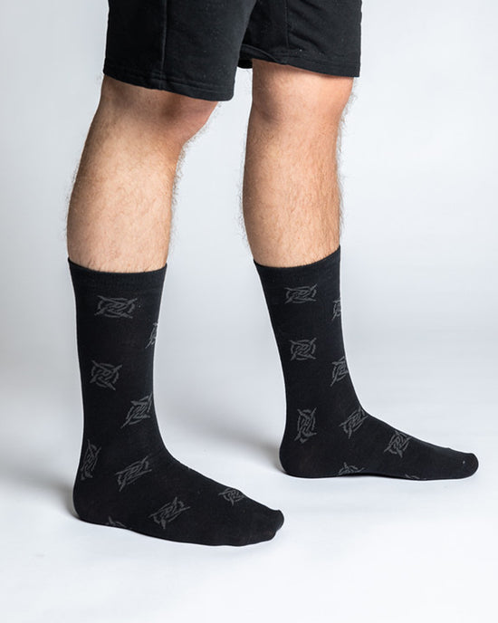 A pair of classic black socks with the Ninjas in Pyjamas logo from NIP merch collection. These comfortable and stylish socks are designed to represent your passion for NIP while adding a touch of ninja-inspired flair to your everyday outfit.