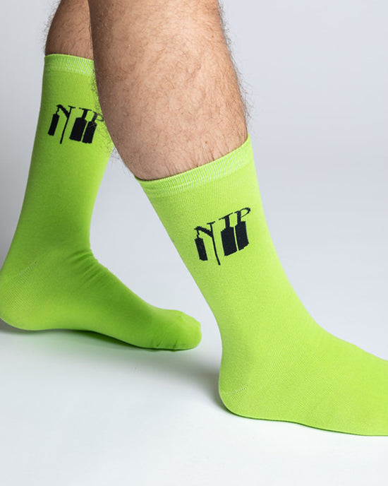 A pair of neon socks with the Ninjas in Pyjamas logo from NIP merch collection. These comfortable and stylish socks are designed to represent your passion for NIP and esports while adding a touch of ninja-inspired flair to your everyday outfit.