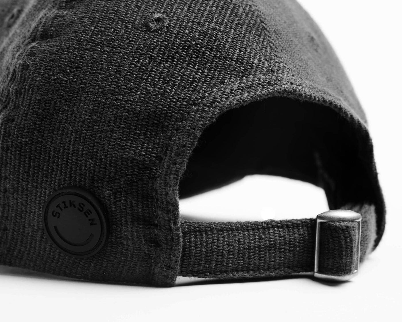 A black ninja cap from the NIP X Stiksen merch collaboration, featuring the Ninjas in Pyjamas logo subtly embroidered on the front. This stylish and adjustable cap is perfect for showcasing your support for NIP in a sleek and trendy way.