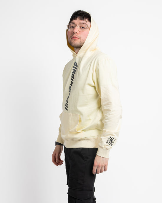 Ninjutsu Collection - Cream Hoodie from Ninjas in Pyjamas Shop. A cream hoodie from the Ninjutsu Merch Collection, featuring the Ninjas in Pyjamas logo subtly printed on the front. This cozy and stylish hoodie is perfect for showcasing your support for NIP while staying warm and comfortable.
