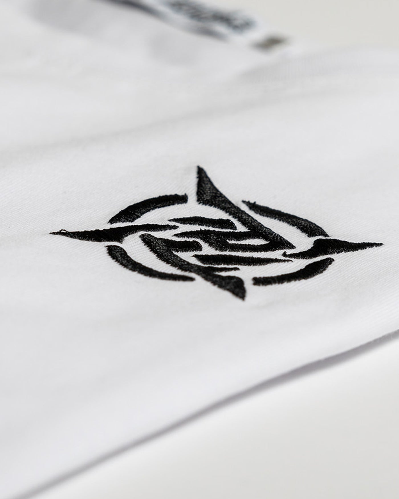 Lagom Collection - White T-shirt from Ninjas in Pyjamas Shop. An image displaying a white t-shirt from the Lagom Collection, featuring the Ninjas in Pyjamas logo subtly printed on the chest. This versatile and trendy t-shirt is a wardrobe essential, allowing you to express your passion for esports and NIP in a sleek and comfortable manner.
