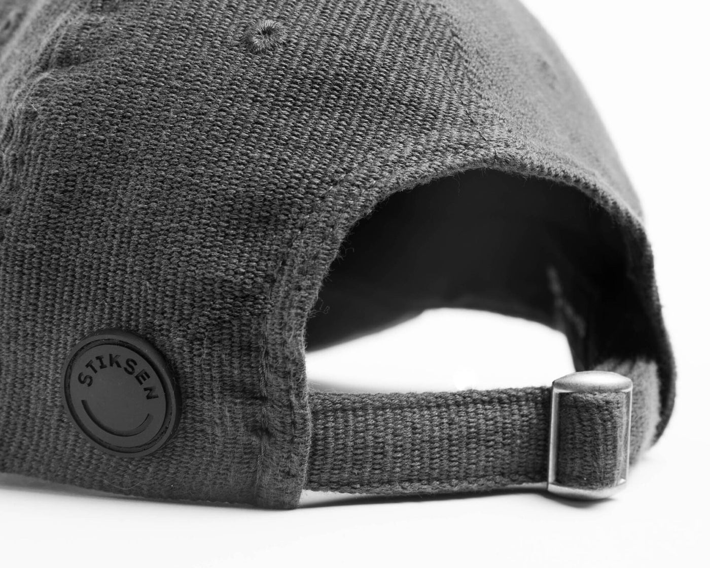 A graphite ninja cap from the NIP X Stiksen merch collaboration, featuring the Ninjas in Pyjamas nickname subtly embroidered on the front. This stylish and adjustable cap is perfect for showcasing your support for NIP in a sleek and trendy way.