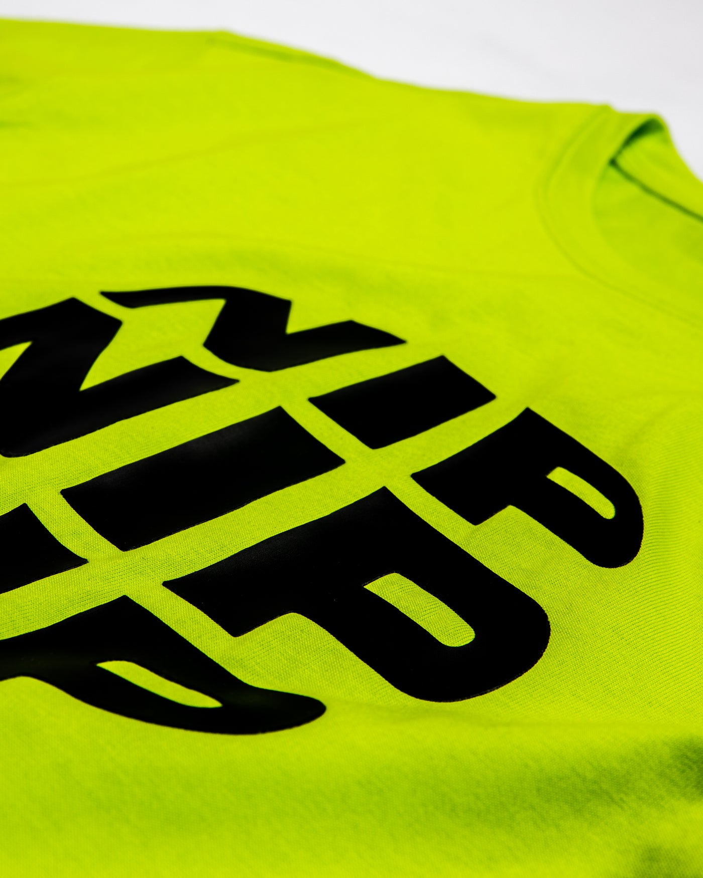 Ninjutsu Collection - Neon Yellow T-Shirt from Ninjas in Pyjamas Shop. A neon yellow t-shirt from the Ninjutsu Merch Collection, with the Ninjas in Pyjamas logo subtly printed on the front. This vibrant and trendy t-shirt is perfect for making a bold statement and showcasing your support for the NIP in a stylish and eye-catching way.